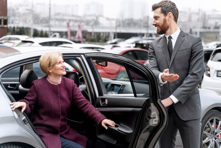 Driver opens car door for a client. Driver Leman.
